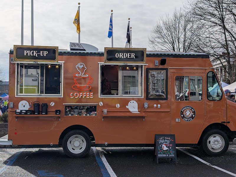 Possessed by Coffee orange coffee truck with ghost branding parked in Montclair NJ