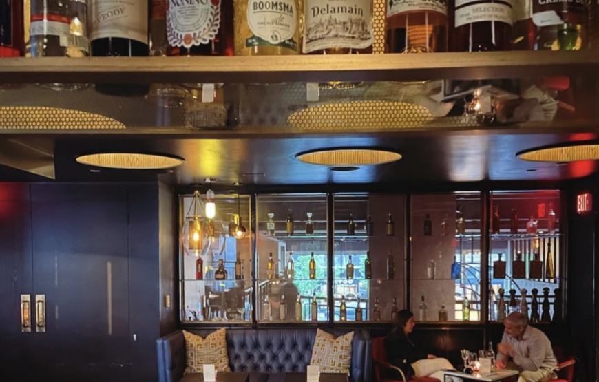 Interior of a Montclair restaurant bar with liquor bottles on display, illustrating New Jersey's liquor license system and local dining scene.