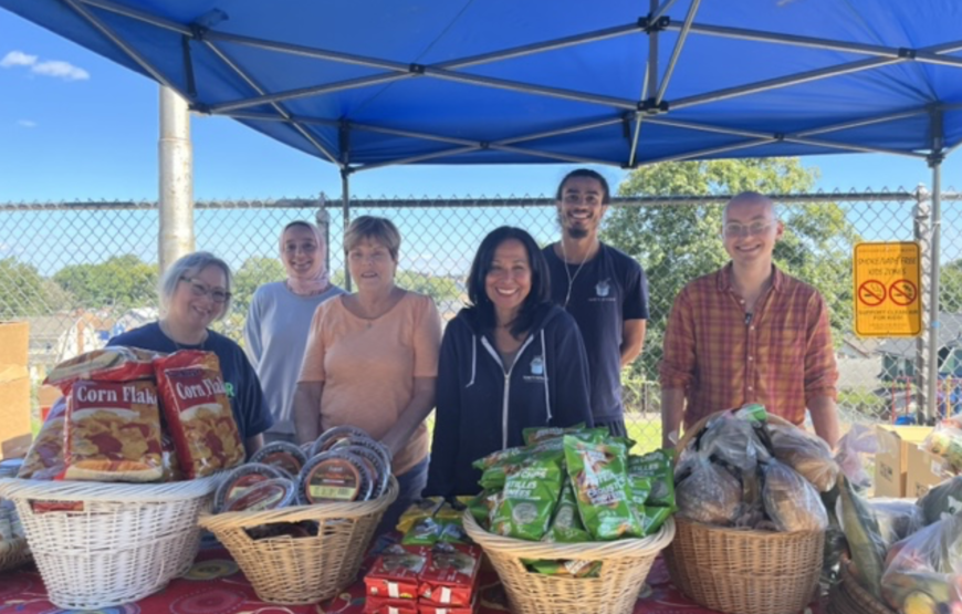 Volunteers distribute groceries and fresh food at a community food assistance event in Montclair, New Jersey.