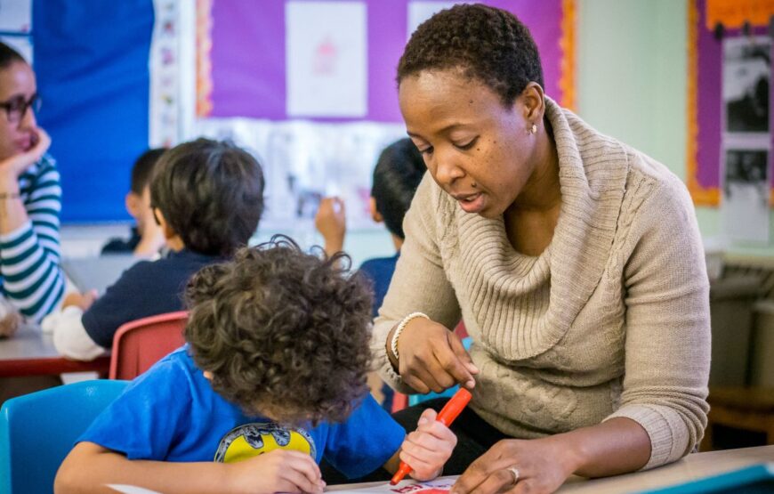 Special education teacher works with students in a classroom setting, illustrating support services and individualized learning programs.