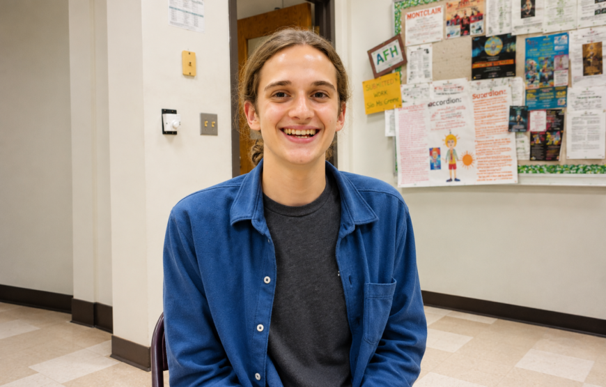 Wyatt Foster, Montclair Board of Education student representative, sits in a school hallway ahead of graduating and attending Brown University.