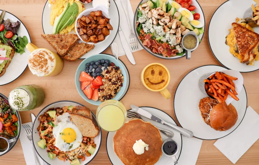 Overhead view of a brunch spread at Toast in Montclair, N.J., with avocado toast, pancakes, breakfast hash and a fried chicken sandwich