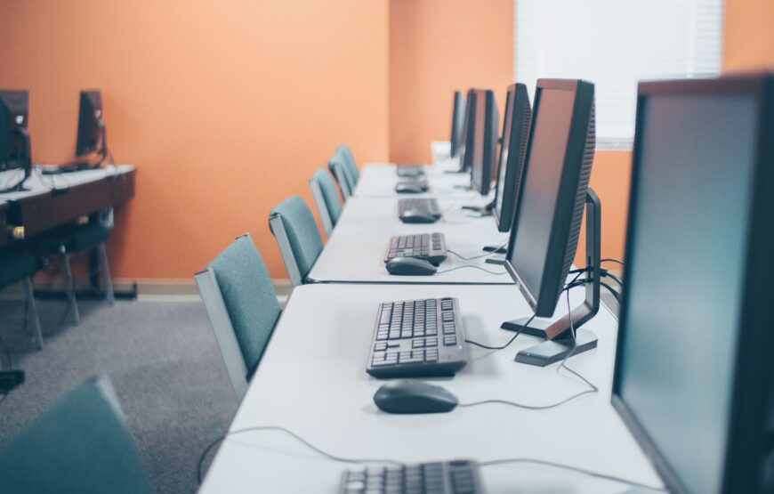 Row of desktop computers and keyboards in a Montclair Public Schools computer lab.