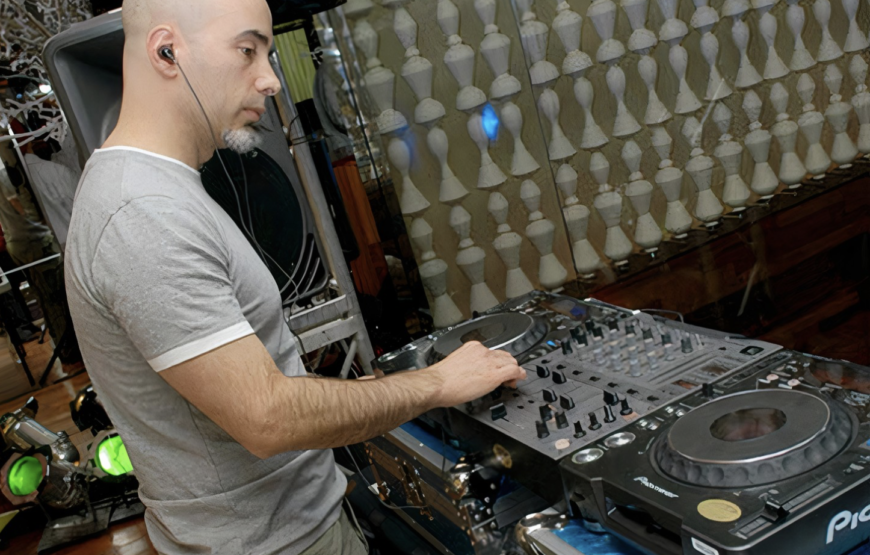 Rafe Gomez DJing behind twin turntables for Danceteria Rewind