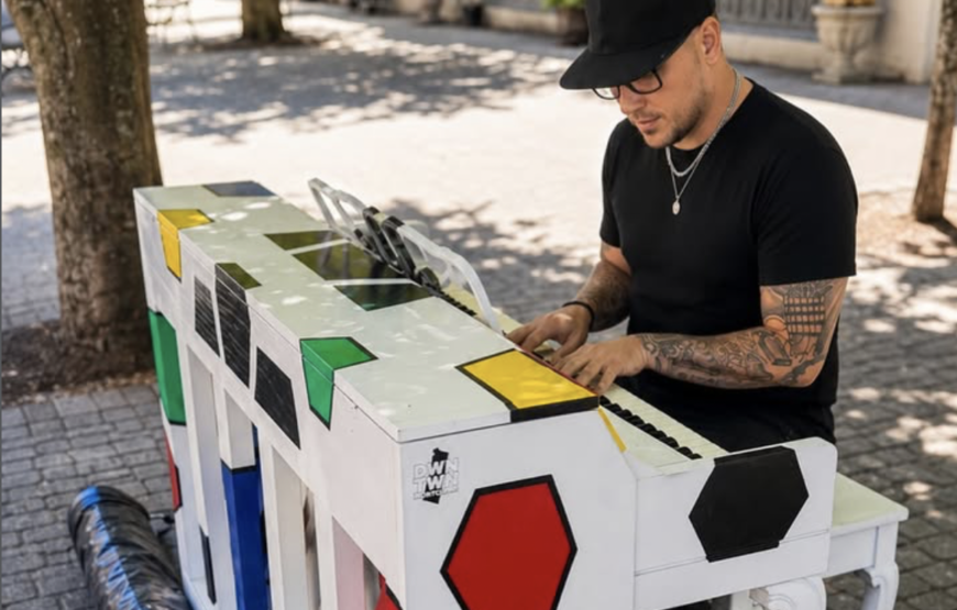 Man playing decorated Church Street piano in downtown Montclair
