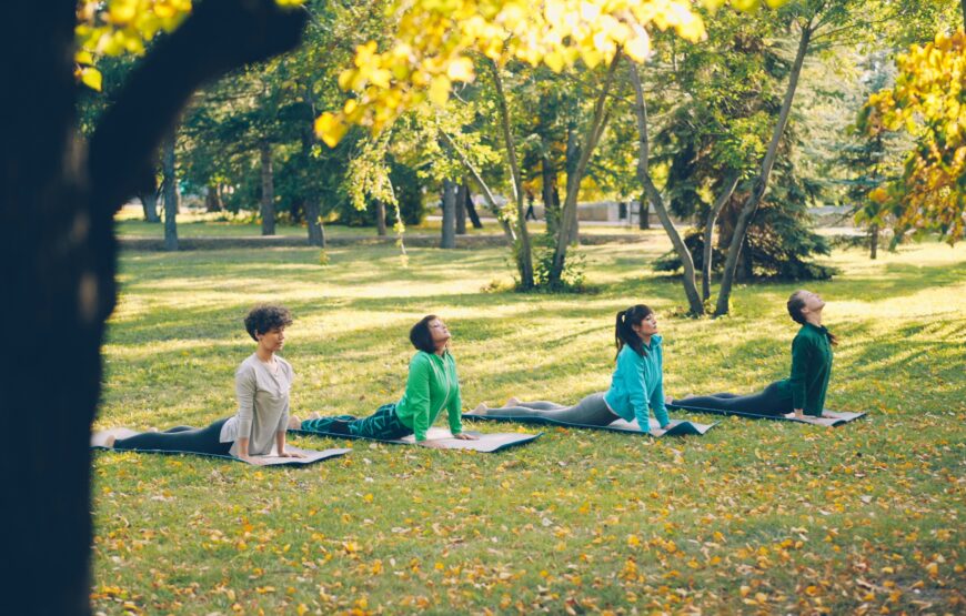 Group yoga class on the grass at an outdoor park, similar to what will take place in Montclair, NJ