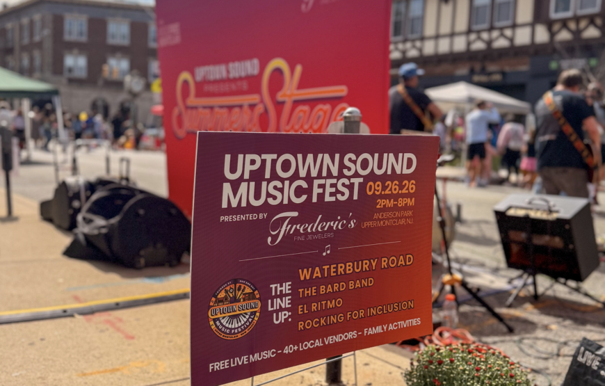 Uptown Sound Music Fest sign at Anderson Park in Upper Montclair, NJ, listing the September 26 lineup including Waterbury Road, The Bard Band, El Ritmo and Rocking for Inclusion