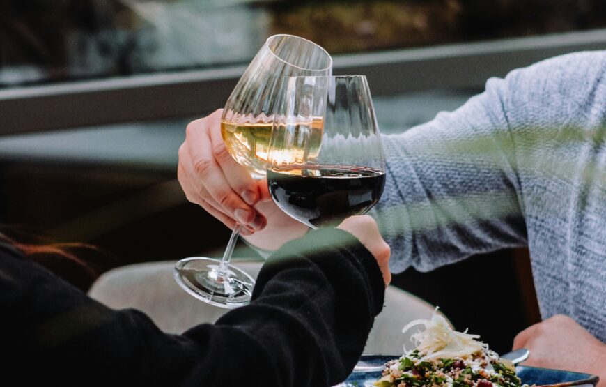 Couple clinking wine glasses over dinner at a restaurant in Montclair, New Jersey
