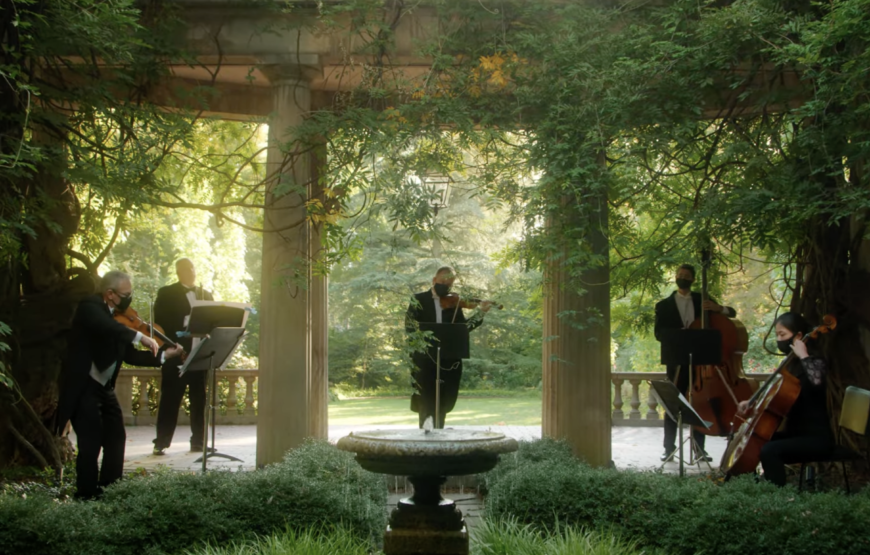 New Jersey Symphony string quartet performing among the trees and stone columns at Van Vleck House & Gardens in Montclair, New Jersey.