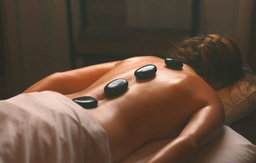 Woman receiving a hot stone massage at a Montclair-area spa